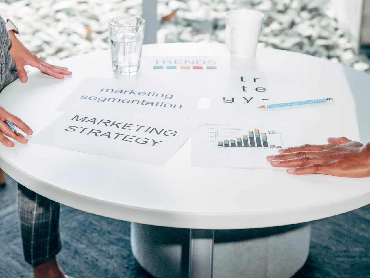 hero-img Two professionals collaborate on marketing strategy and segmentation at a round table.